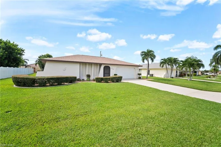 Ranch-style home with a garage and a front yard