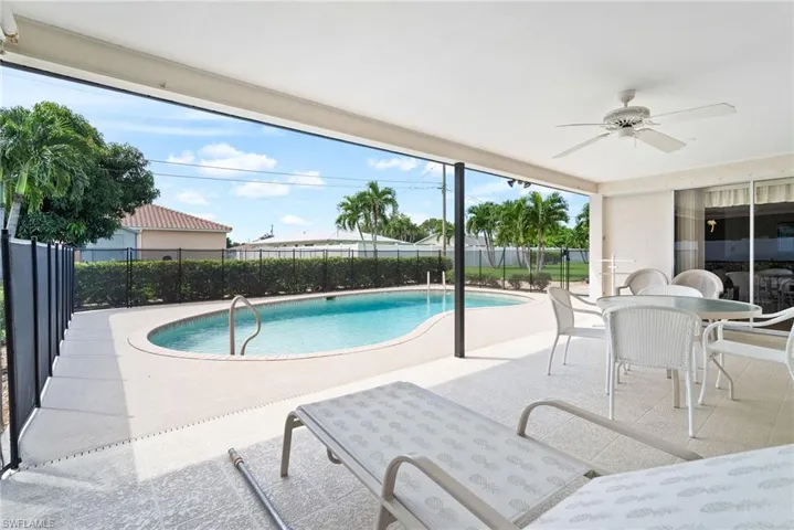 View of pool with ceiling fan and a patio area
