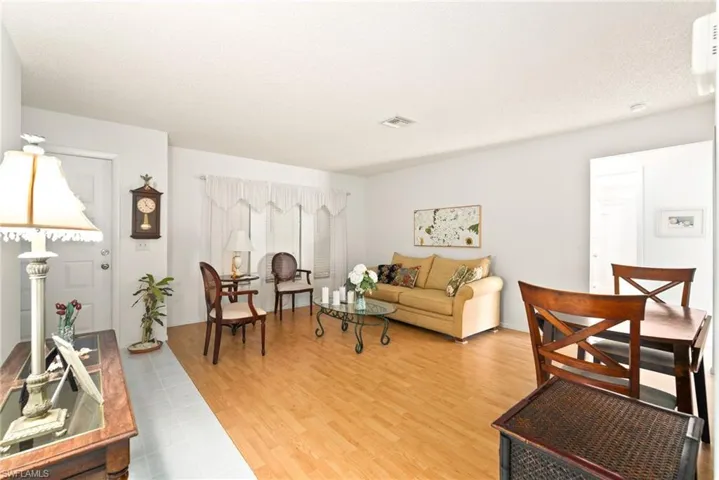 Living room with a textured ceiling and hardwood / wood-style floors