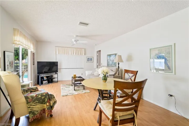 Dining room featuring ceiling fan, a textured ceiling, and hardwood / wood-style floors