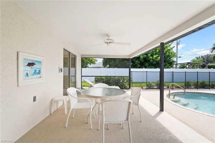 Lanai with ceiling fan and a pool