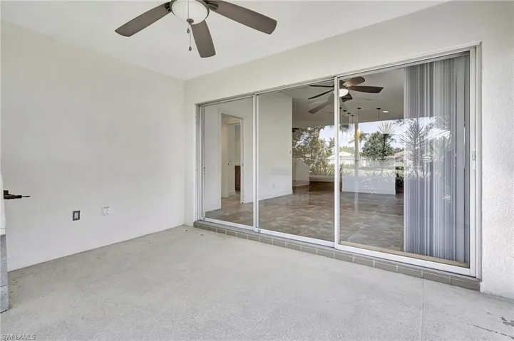 Lanai featuring ceiling fan and lake view.