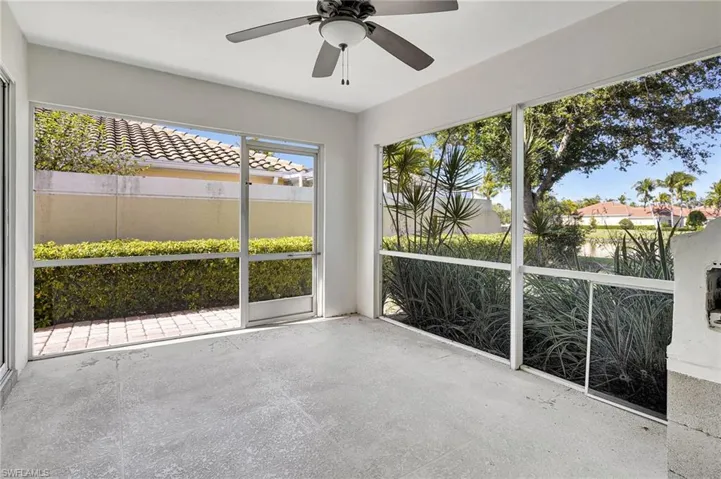 Lanai featuring ceiling fan and lake view.