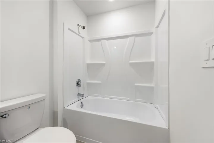 Bathroom with tub / shower combination and toilet
