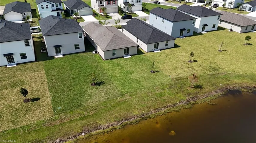 Aerial view of residential area featuring a large body of water