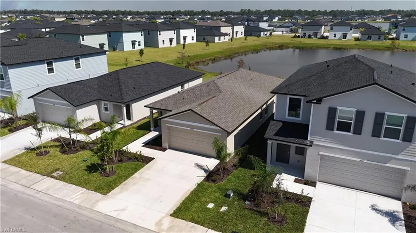 Aerial perspective of suburban area featuring a nearby body of water