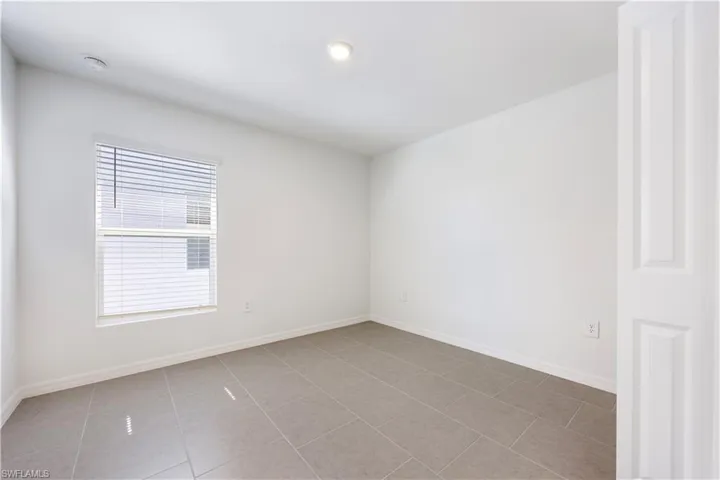 Unfurnished room with baseboards and light tile patterned floors