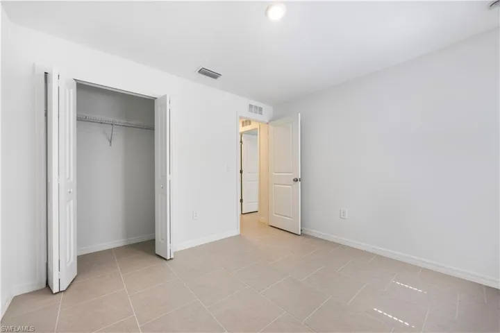 Unfurnished bedroom with light tile patterned floors, a closet, and recessed lighting