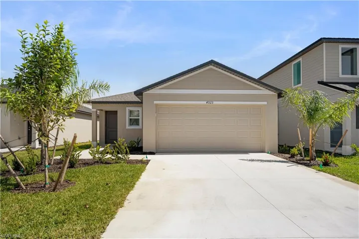 Ranch-style home with driveway, stucco siding, and a garage