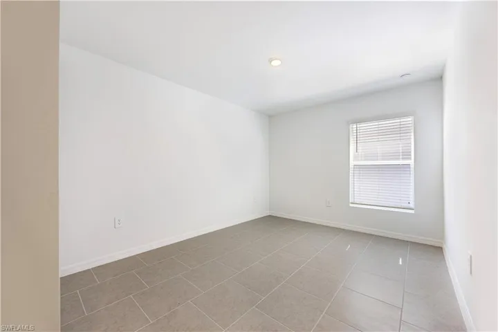 Unfurnished room with baseboards and light tile patterned floors