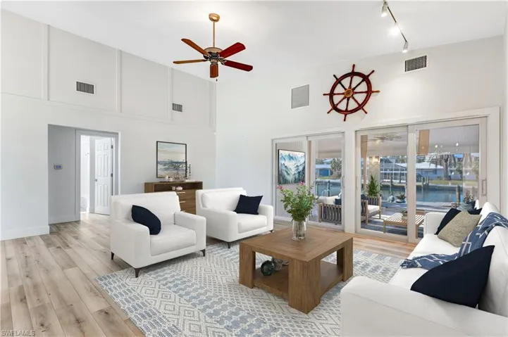 Virtually Staged Living overlooking the sunroom and canal