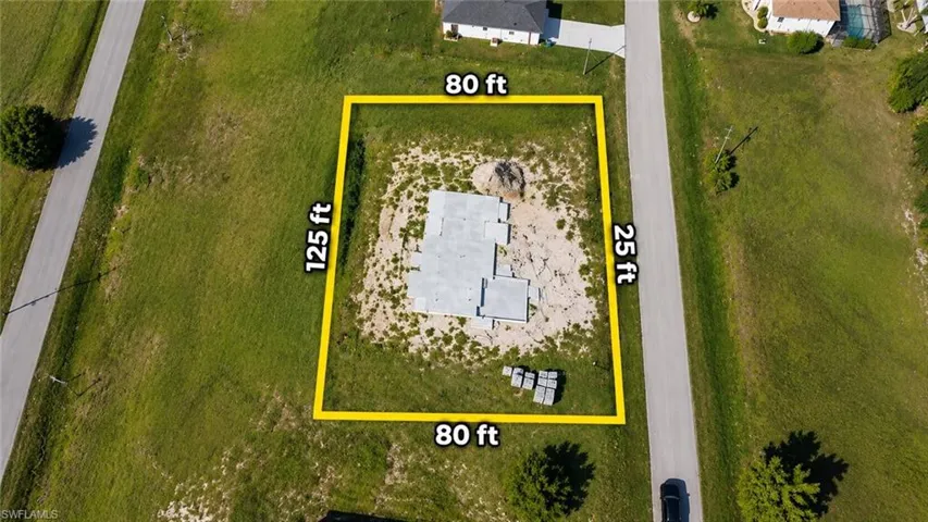 Vacant lot measuring 80 feet by 125 feet featuring a poured concrete foundation