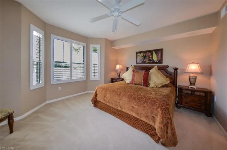Bedroom featuring light carpet and ceiling fan