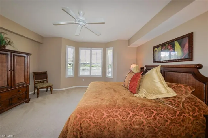 Bedroom featuring light colored carpet and ceiling fan