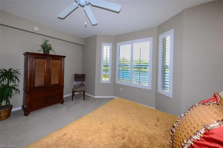 Bedroom with light carpet and ceiling fan