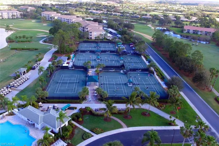 Aerial view of property's location with a golf course and a large body of water