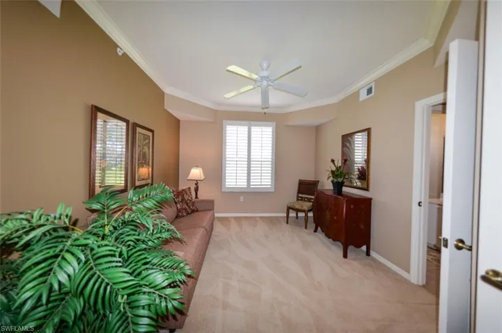 Sitting room featuring crown molding, light colored carpet, and ceiling fan
