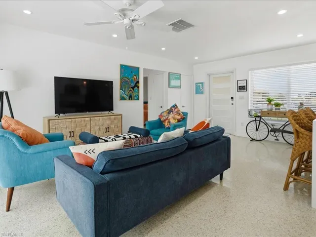 Bright living area featuring terrazzo flooring, recessed lighting, and a ceiling fan