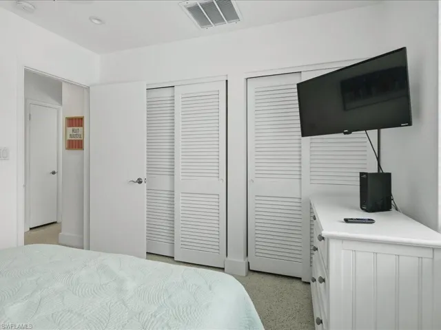 White louvered bi-fold closet doors provide storage