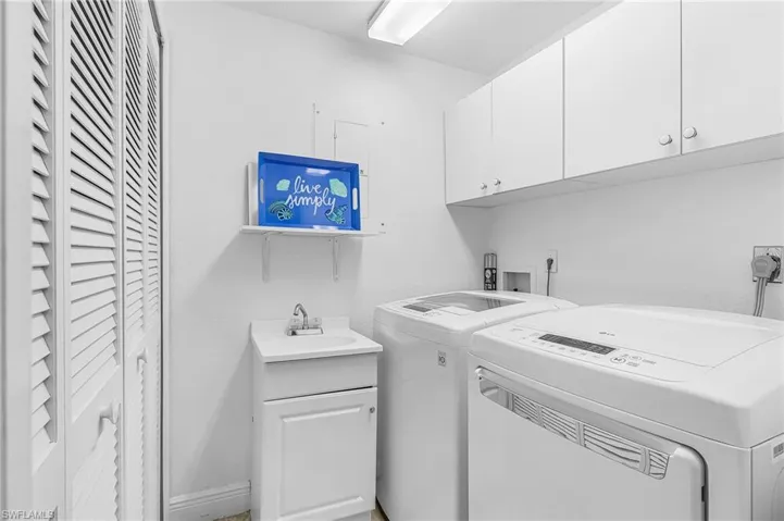 Laundry area featuring cabinet space and washer and dryer