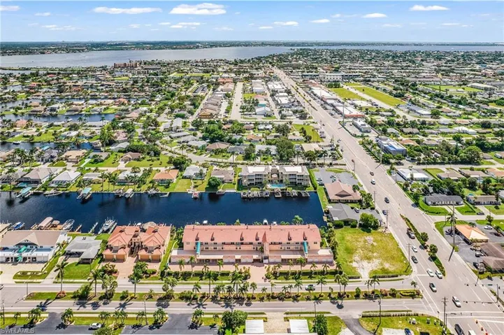 View of property location with a nearby body of water and nearby suburban area