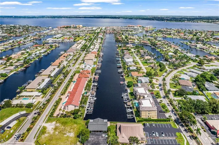 Aerial overview of property's location featuring a large body of water and nearby suburban area