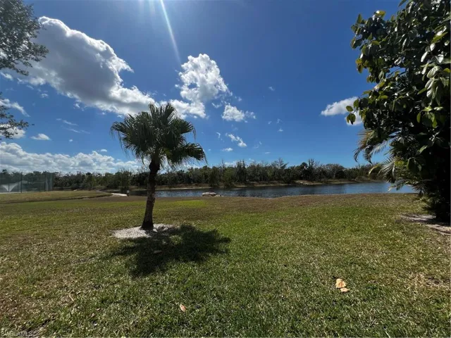 View of green lawn with a water view