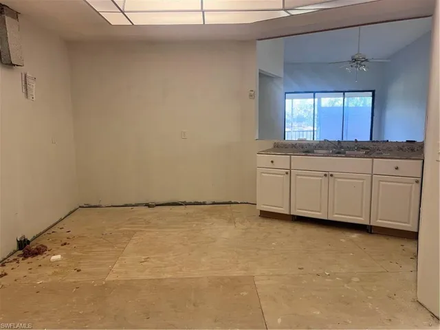 Kitchen with white cabinetry and ceiling fan