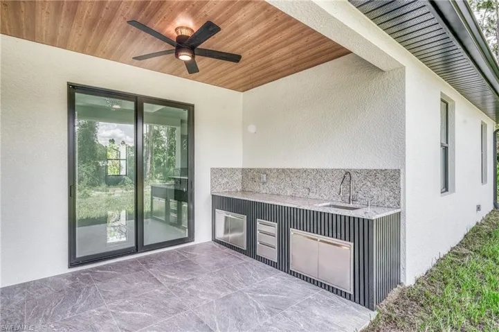 View of patio featuring a ceiling fan and a sink