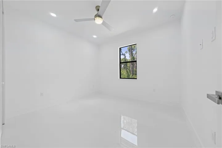 Empty room featuring recessed lighting and a ceiling fan