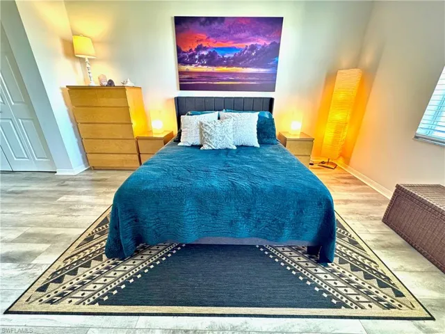 Bedroom with hardwood / wood-style flooring