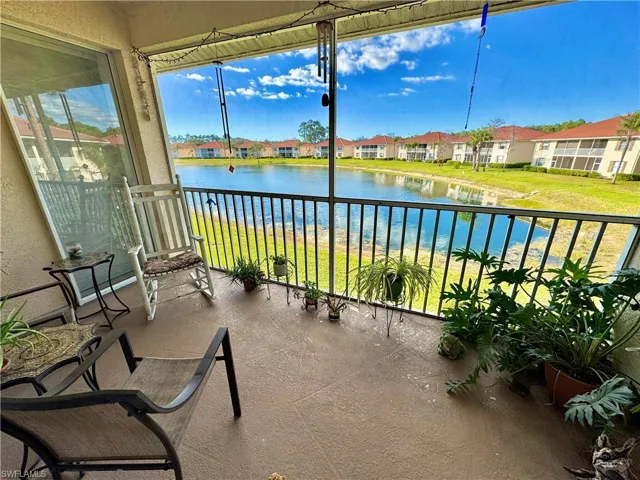 Sunroom featuring a water view