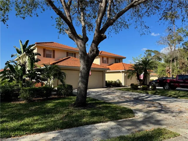 Mediterranean / spanish-style home featuring a garage and a front lawn