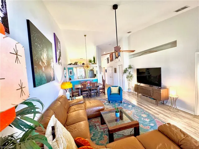 Living room with wood-type flooring and ceiling fan