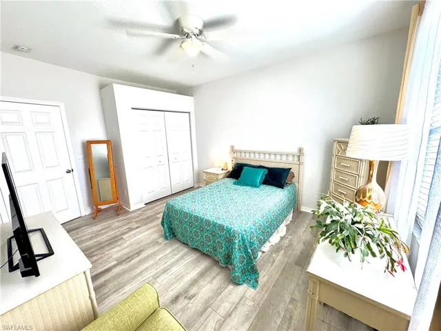 Bedroom featuring hardwood / wood-style flooring, a closet, and ceiling fan