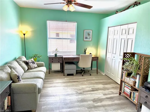 Home office featuring ceiling fan and light hardwood / wood-style floors