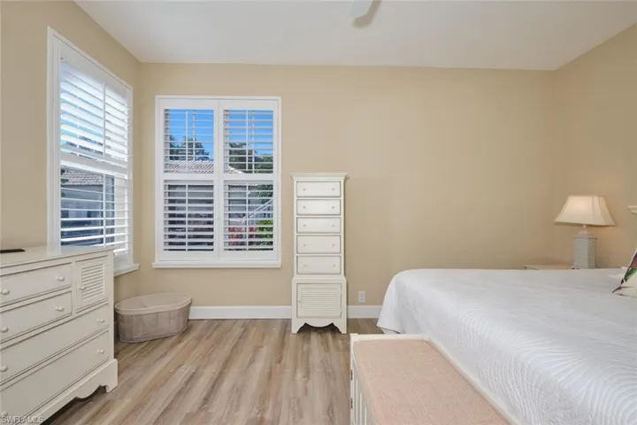 Bedroom with light wood-style floors and a ceiling fan