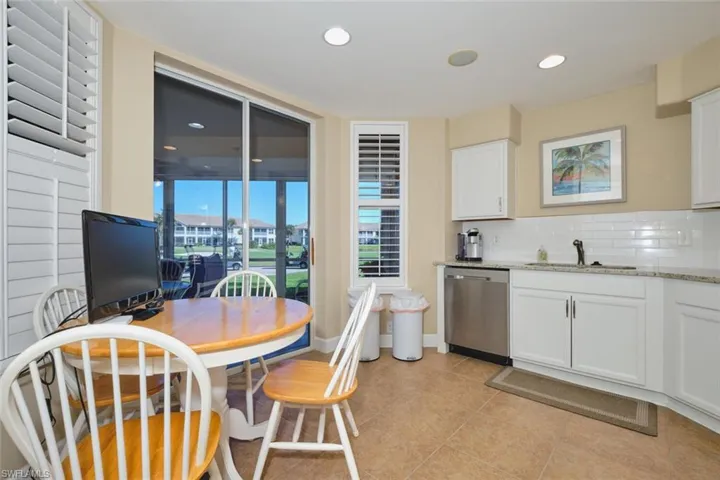 Kitchen with light stone counters, white cabinets, dishwasher, tasteful backsplash, and recessed lighting