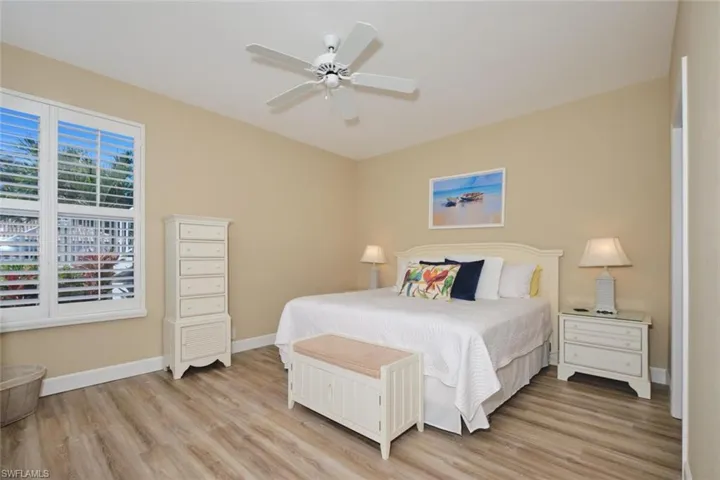 Bedroom with light wood finished floors and a ceiling fan