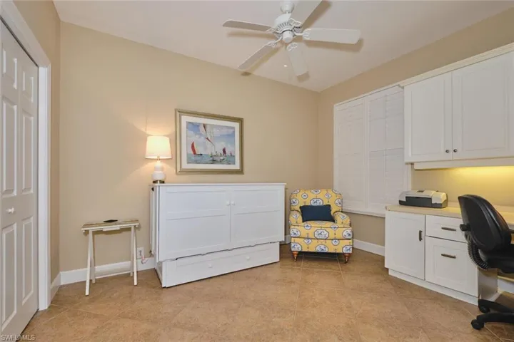 Office space featuring light tile patterned floors and ceiling fan