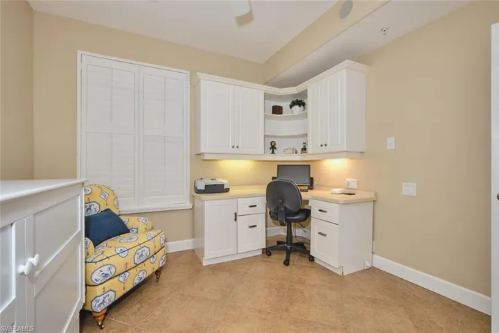Office with built in study area and light tile patterned floors