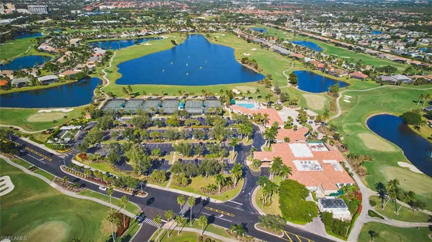 Aerial view of property's location with a golf club and a nearby body of water