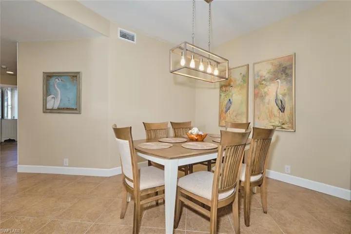 Dining space featuring light tile patterned floors