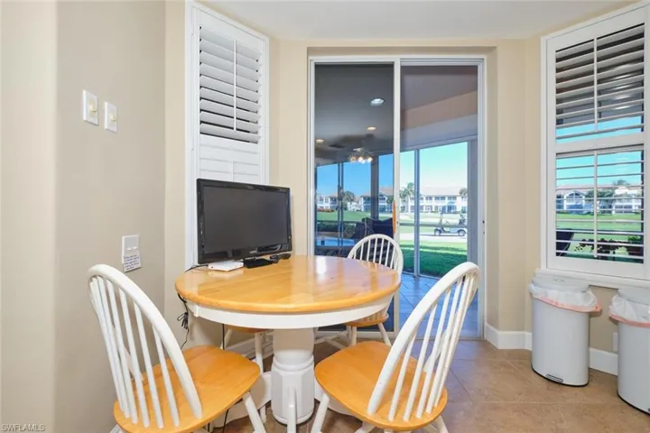 Dining area featuring light tile patterned floors and baseboards