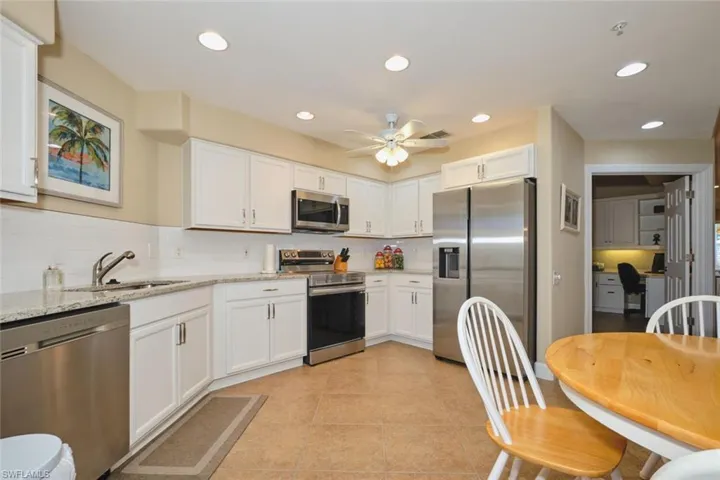 Kitchen featuring stainless steel appliances, recessed lighting, light stone countertops, white cabinetry, and light tile patterned floors