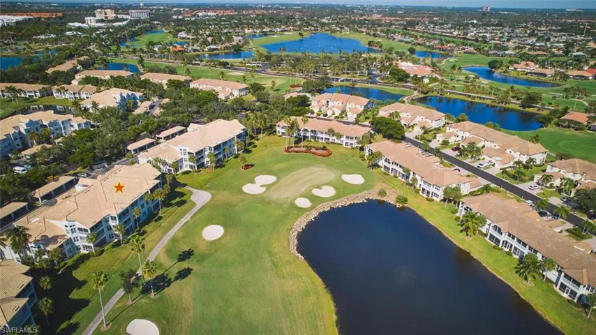 View of property location featuring a golf club and nearby suburban area