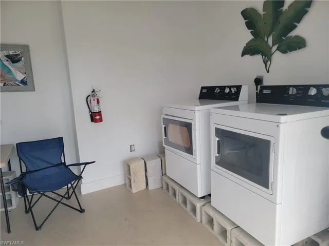 Laundry room featuring washer and dryer and concrete flooring