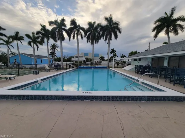 Community pool surrounded by palm trees