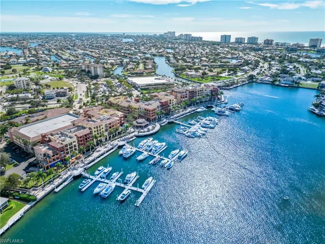 Aerial view featuring a water view and a view of city