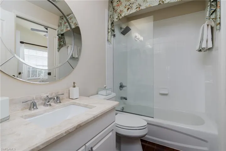 Bathroom featuring a vanity with a light-toned countertop, an undermount sink, and chrome fixtures